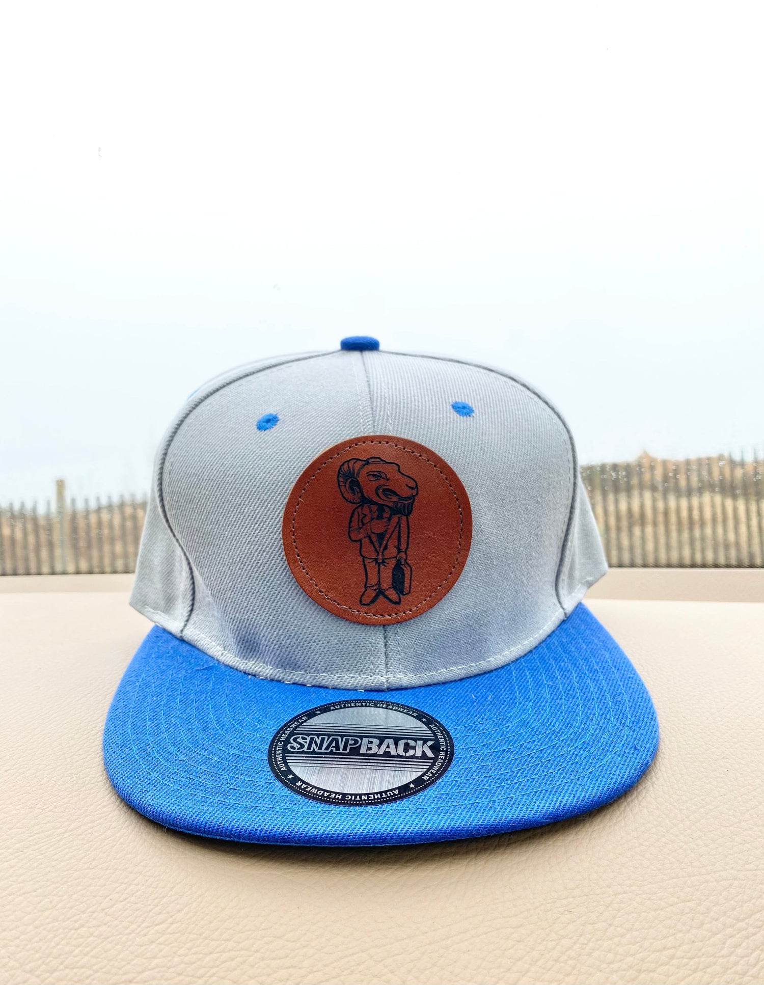 Gray and blue snapback with leather logo patch