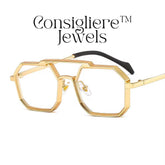 The Consigliere™ Jewels Luxury Sunglasses are high-quality unisex sunglasses with a stylish gold metal frame and polycarbonate lenses. These polygonal sunglasses feature laser engraved branding of the "Consigliere™" name, adding a personalized touch to the design. With a retro 80s and 90s theme, these sunglasses are sure to make a statement and provide both style and protection for any fashion-forward individual.