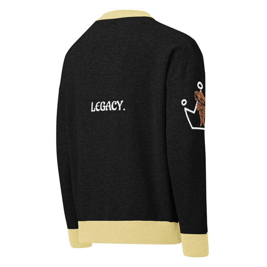 Black, white, and cream knitted sweater.